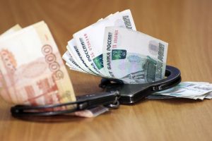 Handcuffs around money